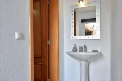 a bathroom with a sink and a mirror on the wall at Vista Mar, a Home in Madeira in Ponta do Sol