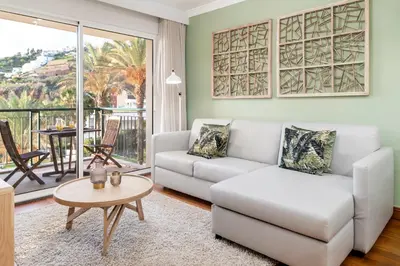 a living room with a couch and a table at Vila Formosa I by An Island Apart in Funchal