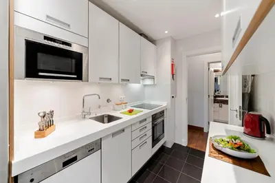a kitchen with white cabinets and a sink at Vila Formosa I by An Island Apart in Funchal
