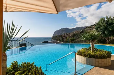 a swimming pool with a view of the ocean at Vila Formosa I by An Island Apart in Funchal