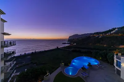 a view of the ocean at dusk from a building at Vila Formosa I by An Island Apart in Funchal