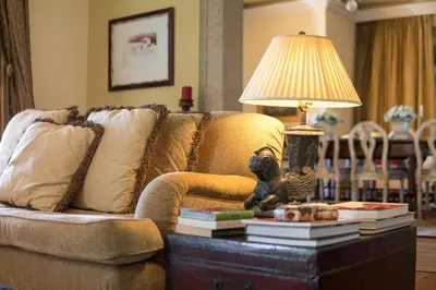 a living room with a couch and a table with a lamp at CASA DA LEVADA in Funchal