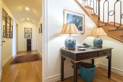 a hallway with a table with two lamps on it at CASA DA LEVADA in Funchal