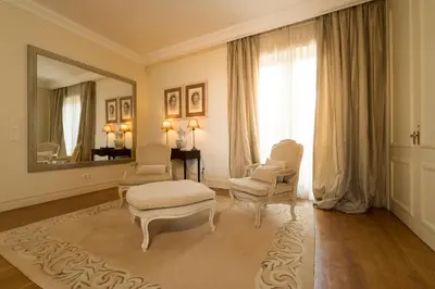 a living room with two chairs and a mirror at CASA DA LEVADA in Funchal