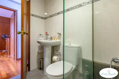 a bathroom with a toilet and a sink at Condo Magnolia in Funchal