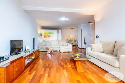 a living room with a white couch and a tv at Condo Magnolia in Funchal