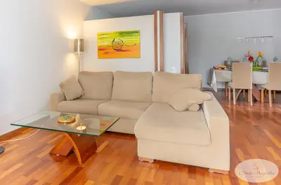 a living room with a couch and a glass table at Condo Magnolia in Funchal