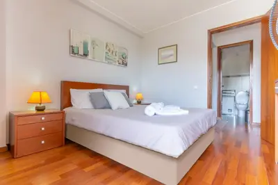 a bedroom with a bed and a dresser and a mirror at Condo Magnolia in Funchal
