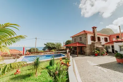 a villa with a swimming pool and a house at Villa Matta by Amazing Madeira in Santana