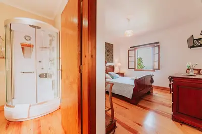 a room with a bedroom with a bed and a window at Villa Matta by Amazing Madeira in Santana