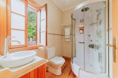 a bathroom with a sink and a shower and a toilet at Villa Matta by Amazing Madeira in Santana