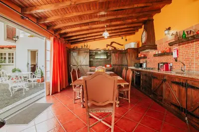 a kitchen with a table and chairs in a room at Villa Matta by Amazing Madeira in Santana