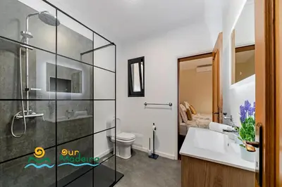 a bathroom with a shower and a sink and a toilet at OurMadeira - BelAir in Funchal