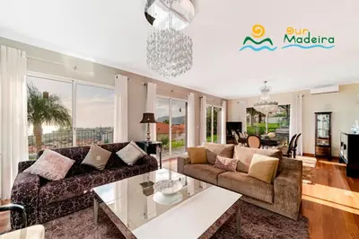 a living room with a couch and a table at OurMadeira - BelAir in Funchal