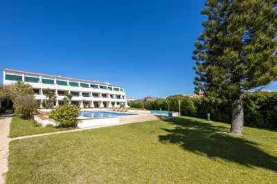 a resort with a swimming pool and a tree at Apartment Julio Pomar, swimming pool in Sagres