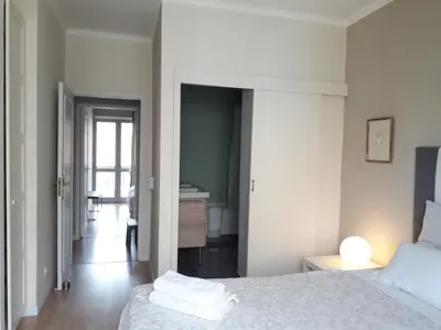 a white bedroom with a bed and a bathroom at Peaceful Top Floor Apt W Balconies - Cambridge RIGHT - AC in Funchal