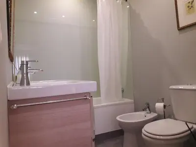a bathroom with a sink and a toilet and a tub at Peaceful Top Floor Apt W Balconies - Cambridge RIGHT - AC in Funchal