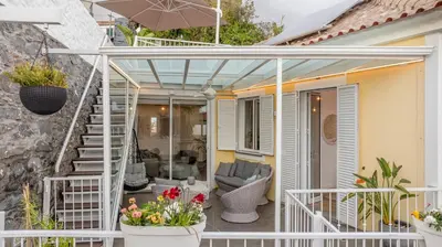 a house with a glass roof and a patio at Little Townhouse Funchal in Funchal