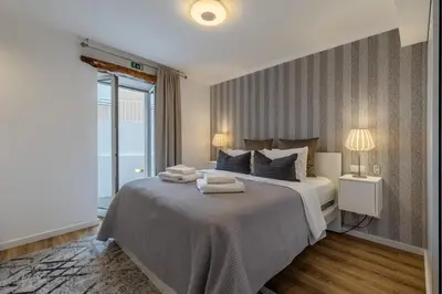a bedroom with a large bed with two towels on it at Little Townhouse Funchal in Funchal