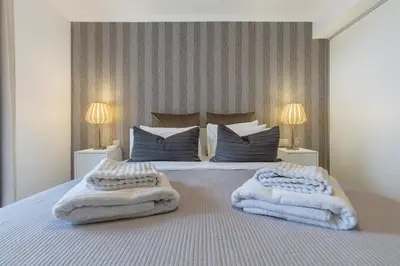 a bedroom with a bed with towels on it at Little Townhouse Funchal in Funchal