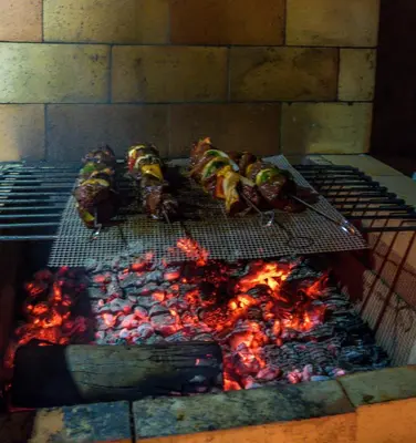 a grill with a bunch of food on it at Little Townhouse Funchal in Funchal