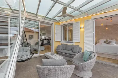 a room with chairs and a couch and a bed at Little Townhouse Funchal in Funchal