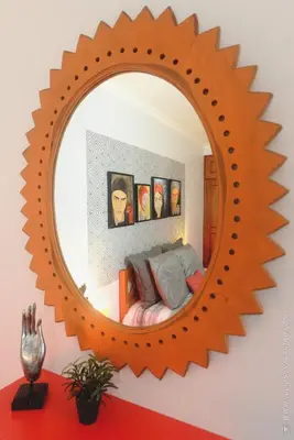 a mirror on a wall with a bed in a bedroom at Apartamento Quinta do Faial in Funchal