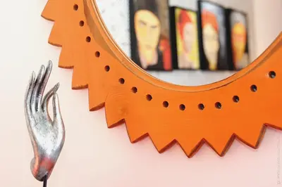 a mirror hanging on a wall next to a fork at Apartamento Quinta do Faial in Funchal