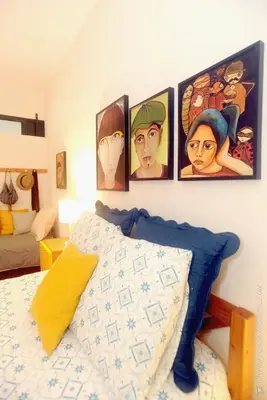 a bedroom with four pictures on the wall at Apartamento Quinta do Faial in Funchal
