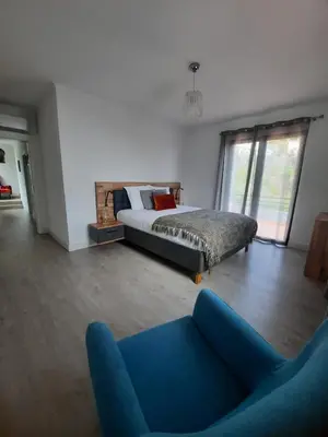 a bedroom with a bed and a blue couch at Casa Gama in Ribeira Brava