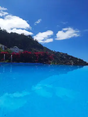 a blue body of water with a mountain in the background at Casa Gama in Ribeira Brava