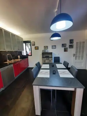 a kitchen with a large table with chairs in it at Casa Gama in Ribeira Brava