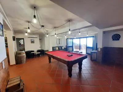a large room with a red pool table in it at Casa Gama in Ribeira Brava