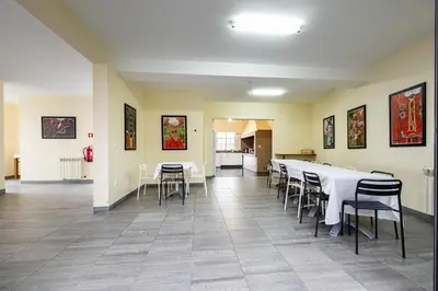 a dining room with white tables and chairs at A Casa do Lagar in São Jorge
