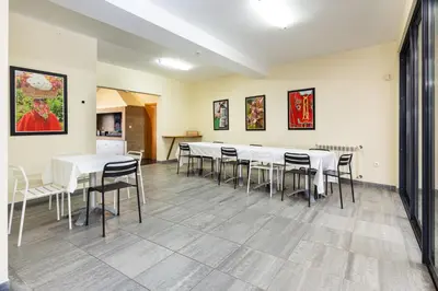 a dining room with white tables and chairs at A Casa do Lagar in São Jorge