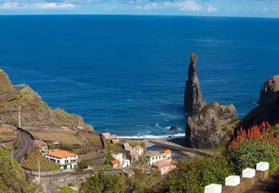 a view of the ocean and a small town on a mountain at A Casa do Lagar in São Jorge