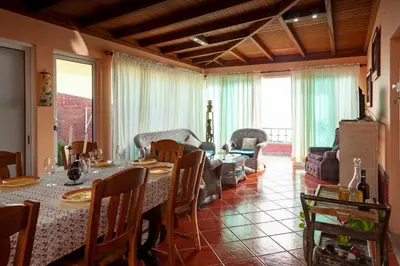 a dining room with a table and a living room at Casa da Maria 15 - Funchal - Famílias in Funchal