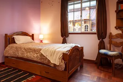 a bedroom with a bed and a window at Casa da Maria 15 - Funchal - Famílias in Funchal