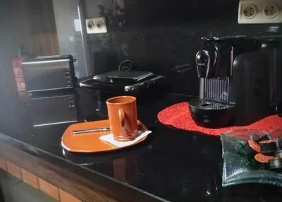 a coffee maker and a coffee cup on a counter at Casa da Maria 15 - Funchal - Famílias in Funchal