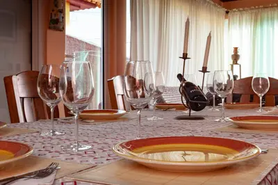 a table with wine glasses and a plate on it at Casa da Maria 15 - Funchal - Famílias in Funchal