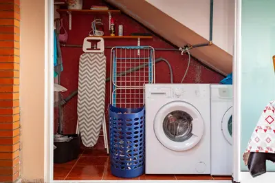 a room with a washing machine and a snowboard at Casa da Maria 15 - Funchal - Famílias in Funchal