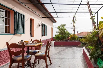 a patio with a table and chairs in a house at Casa da Maria 15 - Funchal - Famílias in Funchal