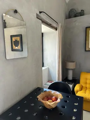 a living room with a yellow couch and a table at THE L lodge, ocean view private garden Cottage in Ribeira Brava