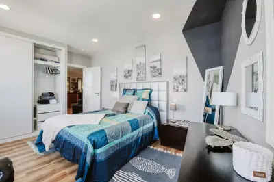 a bedroom with a king sized bed and a table at The Waves Studios by Amazing Madeira in São Vicente