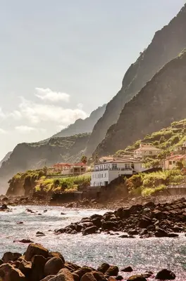 a group of houses on the shore of a beach at The Waves Studios by Amazing Madeira in São Vicente