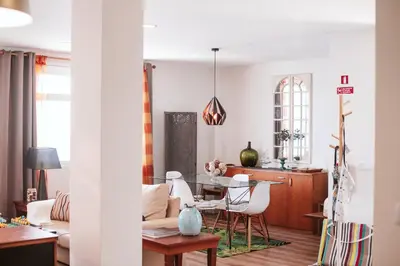 a living room with a table and chairs at The Waves Studios by Amazing Madeira in São Vicente
