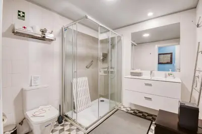a bathroom with a shower and a toilet and a sink at The Waves Studios by Amazing Madeira in São Vicente