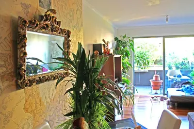 a living room with a mirror and a plant at Rochas Shared Apart Garden Refuge in Funchal
