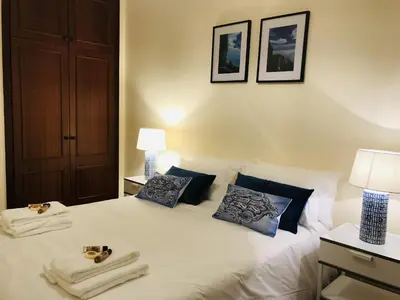 a bedroom with a bed with two towels on it at Golden View by Homie in Funchal