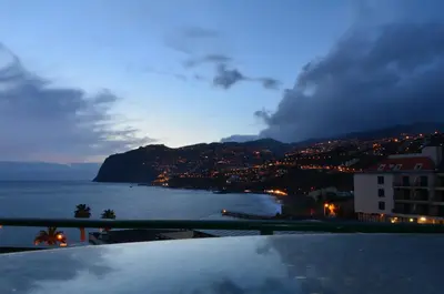 a view of a city and the ocean at night at Golden View by Homie in Funchal